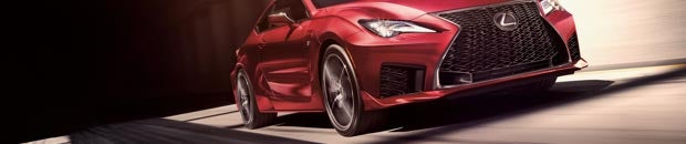 Red Lexus driving down the road