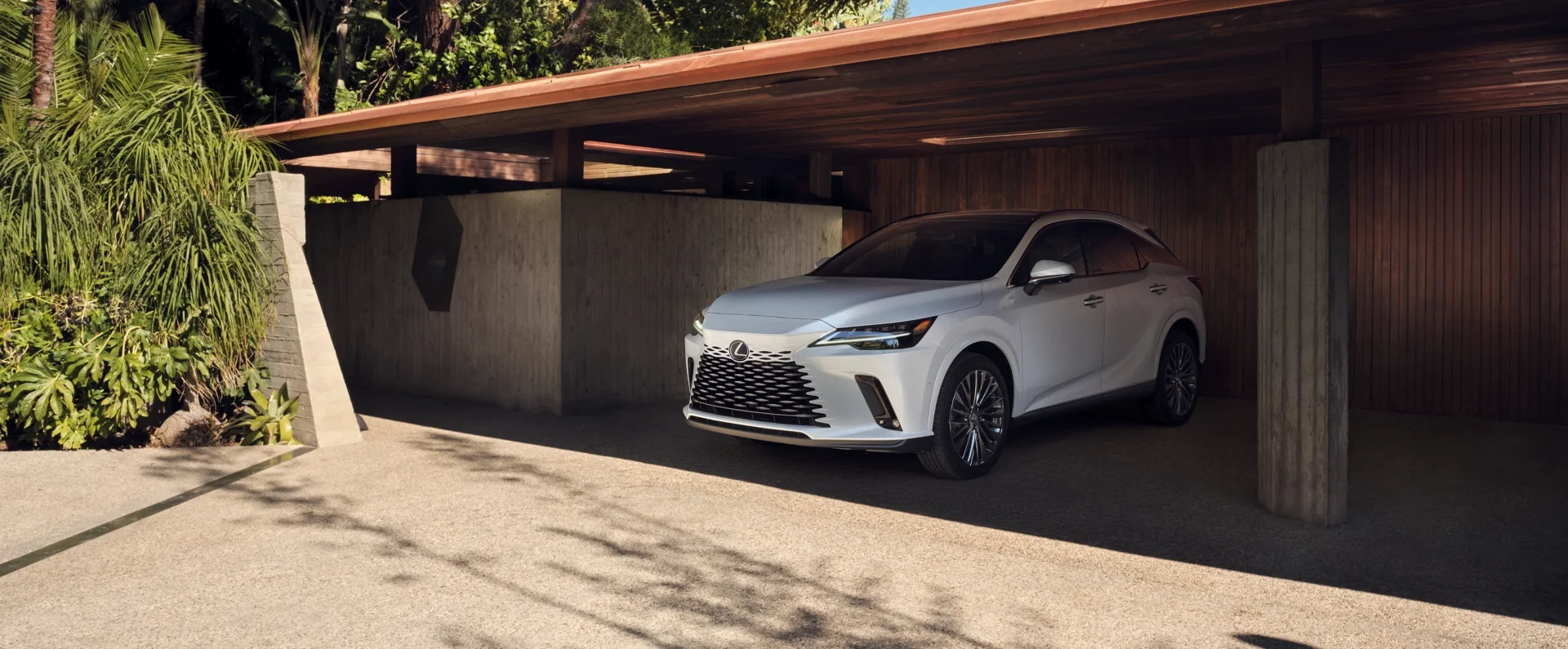 RX 350 Hybrid Luxury all-wheel drive shown in Ultra White underneath a covered parking space.
